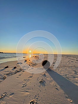 Beautiful beach at sunset, with footprints in the sand in Lancelin, Australia