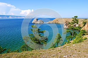 Beautiful beach with trees and rock. The shore of Lake Baikal.