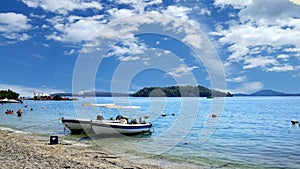 Beautiful beach and two motor boats on Nydri photo