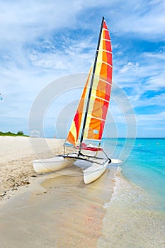 The beautiful beach of Varadero in Cuba with a colorful sailboat