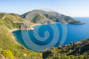 Beautiful beach and water bay in the greek spectacular coast of Peloponnese. Turquoise blue transparent water, unique rocky cliffs