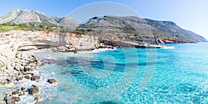 Beautiful beach and water bay in the greek spectacular coast of Peloponnese. Turquoise blue transparent water, unique rocky cliffs