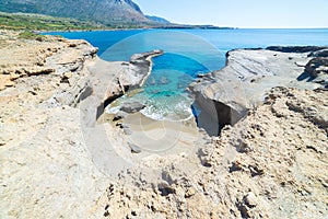 Beautiful beach and water bay in the greek spectacular coast of Peloponnese. Turquoise blue transparent water, unique rocky cliffs