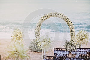 Beautiful beach wedding flower arch setting for wedding venue with panoramic ocean view