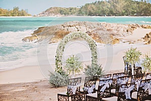 Beautiful beach wedding flower arch setting for wedding venue with panoramic ocean view