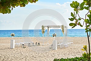 Beautiful beach wedding venue setting with flowers decoration, panoramic ocean view