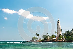 Beautiful beach and White lighthouse Dondra in Sri Lanka.