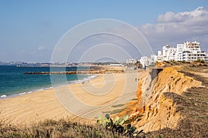 Beautiful beaches and cliffs in Quarteira, Algarve, Portugal photo