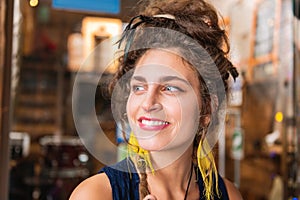 Beautiful beaming woman wearing bright yellow earrings