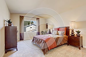 Beautiful bedroom with bright orange bedding