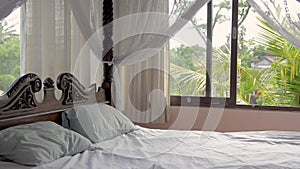 Beautiful bedroom with a four poster bed in a luxury private holiday villa rental in rainforest in Asia. Bali, Sri Lanka