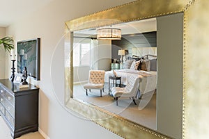 Beautiful Bedroom Reflection in Decorative Mirror.
