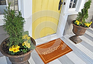 Beautiful beige Welcome zute doormat with Border outside home with yellow flowers and leaves