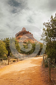 Beautiful Bell Rock and trail in red rock formations within coconino national forest in Sedona Arizona USA against white cloud