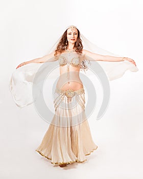 Beautiful belly dancer turning with veil