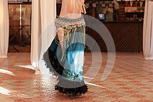 Beautiful belly dancer young woman in gorgeous red and green costume dress