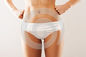 Beautiful belly. gray studio background