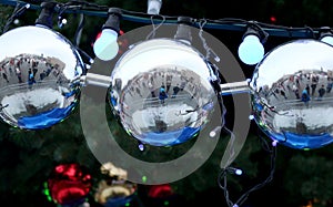 Beautiful, big balls on the Christmas tree in which the whole city is reflected