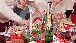 Beautiful big family preparing to eat and man slicing turkey