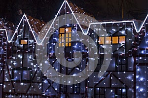 Beautiful big house decorated with Christmas lights. Large Windows with Christmas tree.