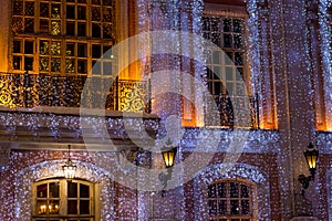 Beautiful big house decorated with Christmas lights. Large Windows with Christmas tree.