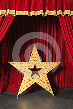 Beautiful big shining star on red stage in retro