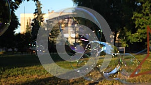 Beautiful and Big soap bubbles fly in the air, slow motion, close up