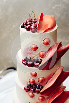 Beautiful big three-story cherry-colored wedding cake one