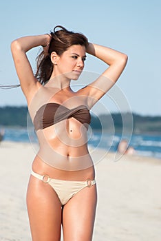 Beautiful bikini model posing on the beach