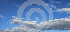 Beautiful billowing clouds (cumulus) in the deep blue sky.