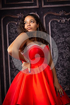 Beautiful, Biracial High School Senior wearing red prom dress