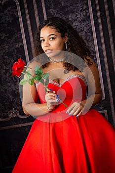 Beautiful, Biracial High School Senior wearing red prom dress