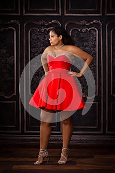 Beautiful, Biracial High School Senior wearing red prom dress