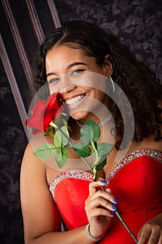 Beautiful, Biracial High School Senior wearing red prom dress