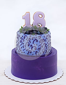 Beautiful birthday cake in lilac tones with the number eighteen