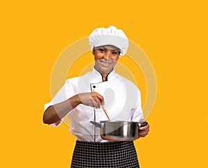 Beautiful Black Chef Woman With Spatula Stirring Food In Saucepan