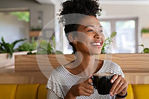 Beautiful black girl drinking coffee at cafe