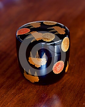 A beautiful black lacquered tea caddy with auspicious designs