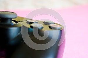 A beautiful black modern digital game joystick to control a video game console for video games with buttons and keystrokes