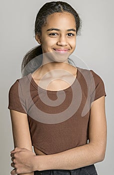 Beautiful black teen posing on studio gray background