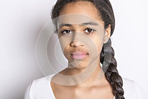 Beautiful black teen posing on studio white background looking sad