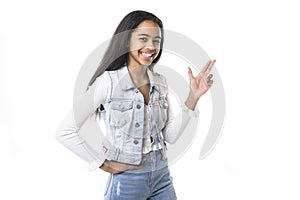 Beautiful black teen posing on studio white background pointing something