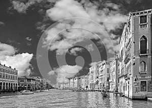 Beautiful black and white aerial view of the Grand Canal near the Rialto market, against a dramatic sky, Venice, Italy