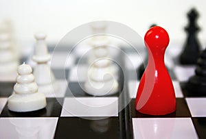Beautiful black and white contrast with red ludo figure on chessboard. Conceptual leadership game photo