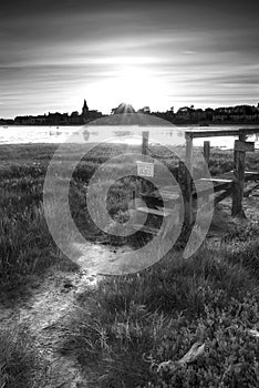 Beautiful black and white low tide landscape of Bosham Harbour w