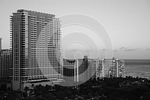 Beautiful black and white picture of the buildings alongside the ocean