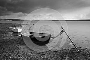 Beautiful black and white sunset landscape image of boats moored