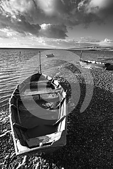 Beautiful black and white sunset landscape image of boats moored