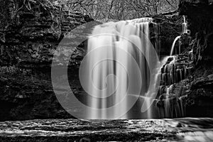 Beautiful black and white waterfall landscape image in forest du