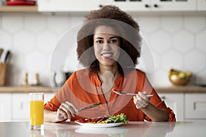 Beautiful Black Woman Eating Tasty Breakfast Or Lunch In Kitchen At Home